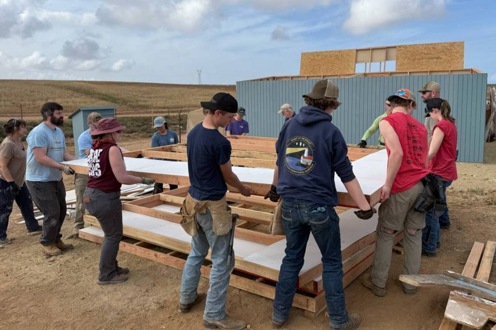 Photo courtesy Keith Sandell/
Sequim Community Church team members lift together a portion of a new home they constructed in Mexico during spring break.