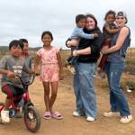 Aliya Smith and Kayhbree Henderson play with local children in Vicente Guerrero in Baja California, Mexico. They were part of a mission trip team that built two homes for a family of four and a family of five.
