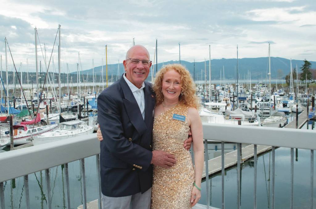 Newlyweds Joel Cziok and Jenn Gibbings pause for a photo at John Wayne Marina amidst the Sequim Bay Yacht Clubs 50th anniversary celebration.