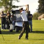 Sequim Gazette photo by Matthew Nash/
Cody Dunscomb shoots from the fairway with an audience behind him and teammate Adrian Aragon during an April 23 match with Kingston.