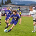 Photo by Emily Matthiessen/ Sequims Max Stanford drives past a North Mason player as teammate Colton Wagner looks on during the game on April 21 in Sequim.