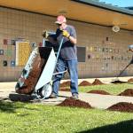 Sequim Gazette photos by Matthew Nash
Dungeness Community Church volunteers Steve Young and Sue Schaafsma help spread bark at Helen Haller Elementary during Sequim Beautiful Day. Young said the event is a good way to show that church members care about their community.