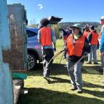 Paula Huls, a volunteer with Habitat for Humanity of Clallam County, helps load a dumpster during the Rally in the Alley event on April 25 in Carrie Blake Community Park. She said it was her second time helping and she just wants to give back to the community and help people with spring cleaning.