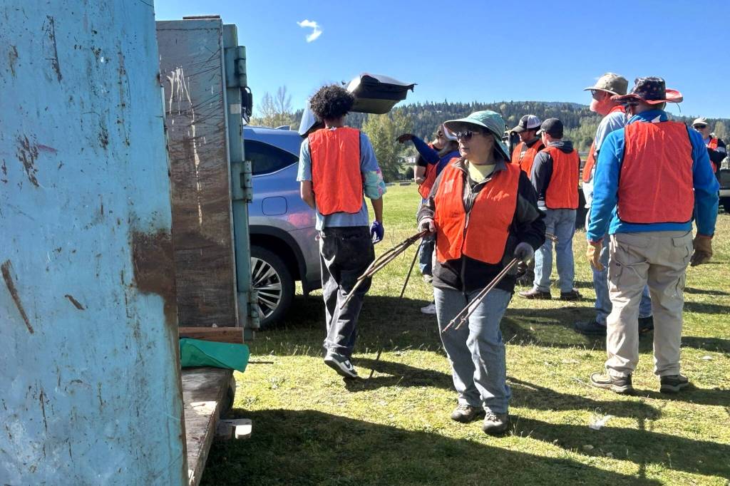 Paula Huls, a volunteer with Habitat for Humanity of Clallam County, helps load a dumpster during the Rally in the Alley event on April 25 in Carrie Blake Community Park. She said it was her second time helping and she just wants to give back to the community and help people with spring cleaning.