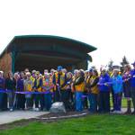 Brian Pulk, president of the Sequim Valley Lions Club, cuts a ribbon to celebrate a paved pathway around the James Center for the Performing Arts. The Lions paid about $50,000 for the project.