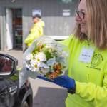 The communitys support of the Sequim Food Bank is evident in other ways besides donations of money and food. Here, volunteer Marilyn Pulk offers a bouquet of flowers donated by a local grocery store to a food bank client.