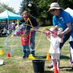 Sequim Gazette photo by Monica Berkseth/ Quinn Pierce, 2, enjoys bubbles at the Olympic Peninsula YMCAs Family Fun Days station on Saturday.
