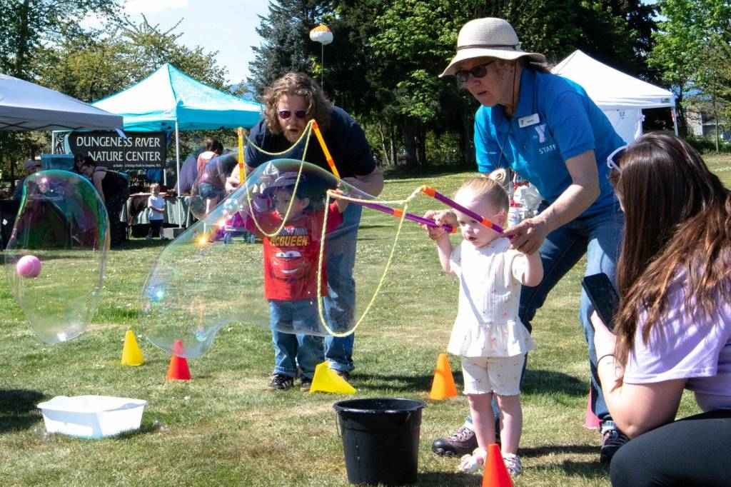 Sequim Gazette photo by Monica Berkseth/ Quinn Pierce, 2, enjoys bubbles at the Olympic Peninsula YMCAs Family Fun Days station on Saturday.