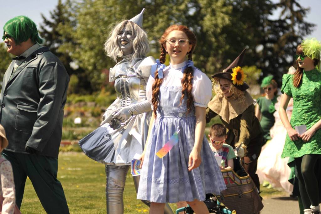 Sequim Gazette photo by Matthew Nash/ Lily Tjemsland, the Tin Girl, and Trinity Devlin, as Dorothy, walk in the Kids Parade promoting the operetta The Wizard of Oz. It continues May 8-10 with shows at 7 p.m. Friday-Saturday, and 2 p.m. Sunday.
