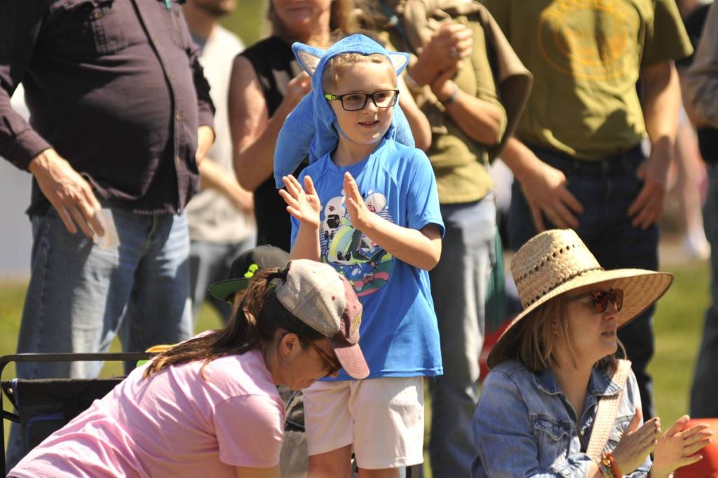 Sequim Gazette photo by Matthew Nash/ Harrison Wahlberg, 6, claps for winners of the Kids Parade on May 2. He dressed as Sonic the Hedgehog.