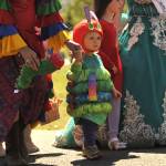 Bruce Henry Pinnell, 2, walks dressed as the Hungry Little Caterpillar for the Kids Parade on May 2. He won first place for his Storybook Costume. His mom Jennifer Wilson dressed as Carmen Miranda.