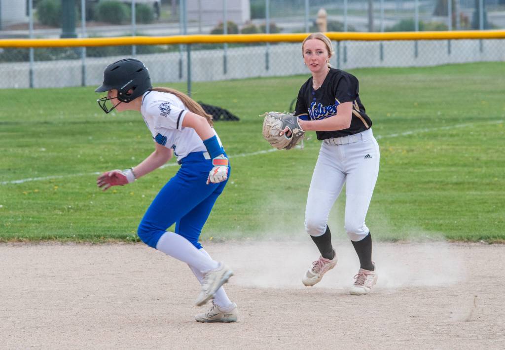 Photo by Emily Matthiessen/ Sequims Ava Ritter looks to throw to first base around a North Mason baserunner in Sequim on April 27.