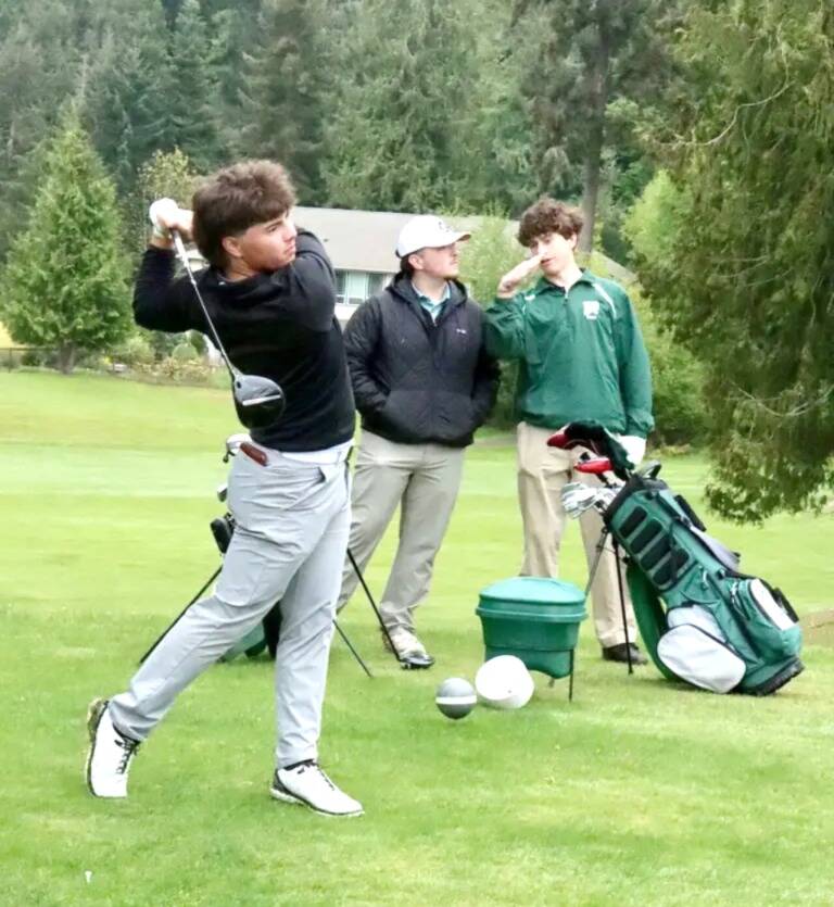 Photo by Dave Logan/ Sequims Adrian Aragon tees off by Port Angeles Max Gagnon and Sky Gelder at the seventh tee at Peninsula Golf Club on April 28 in the Duke Streeter Invitational.