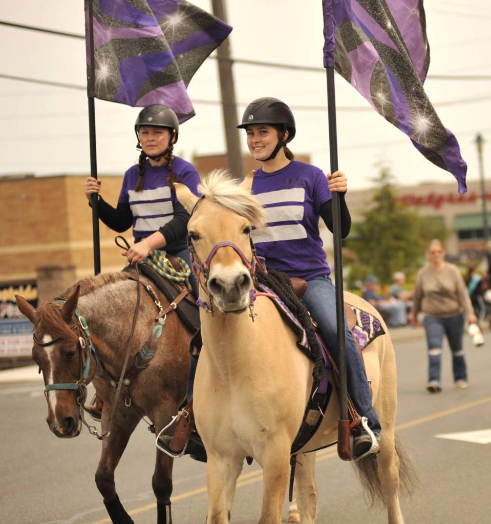 Sequim Gazette photo by Matthew Nash/ Sequim High Schools Equestrian Team trots along during the Grand Parade.