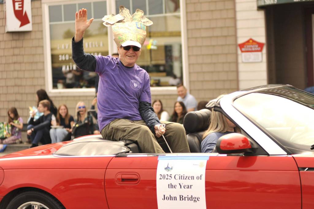 Sequim Gazette photos by Matthew Nash 
John Bridge, Sequim-Dungeness Valley Chamber of Commerces 2025 Citizen of the Year, waves to the crowd during the Grand Parade while wearing a fun hat.