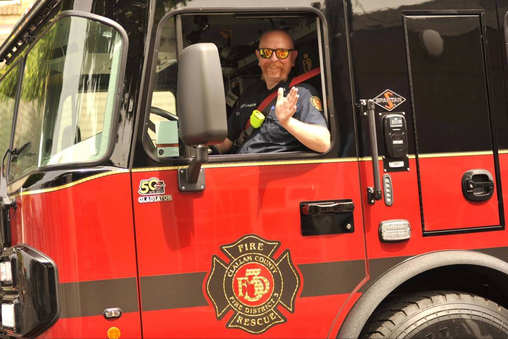 Sequim Gazette photo by Matthew Nash/ Captain Marc Lawson with Clallam County Fire District 3 drives one of the districts new fire engines during the Grand Parade.