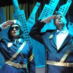 Officer Barrel (Shahida Shahir) and Officer Lockstock (Kyle LeMaire) patrol Urinetown as its top cops.