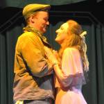 Sequim Gazette photo by Matthew Nash/ Hayden Pomeroy and Sunshine Peterson, as Bobby and Hope, embrace during a musical number in Urinetown the Musical.