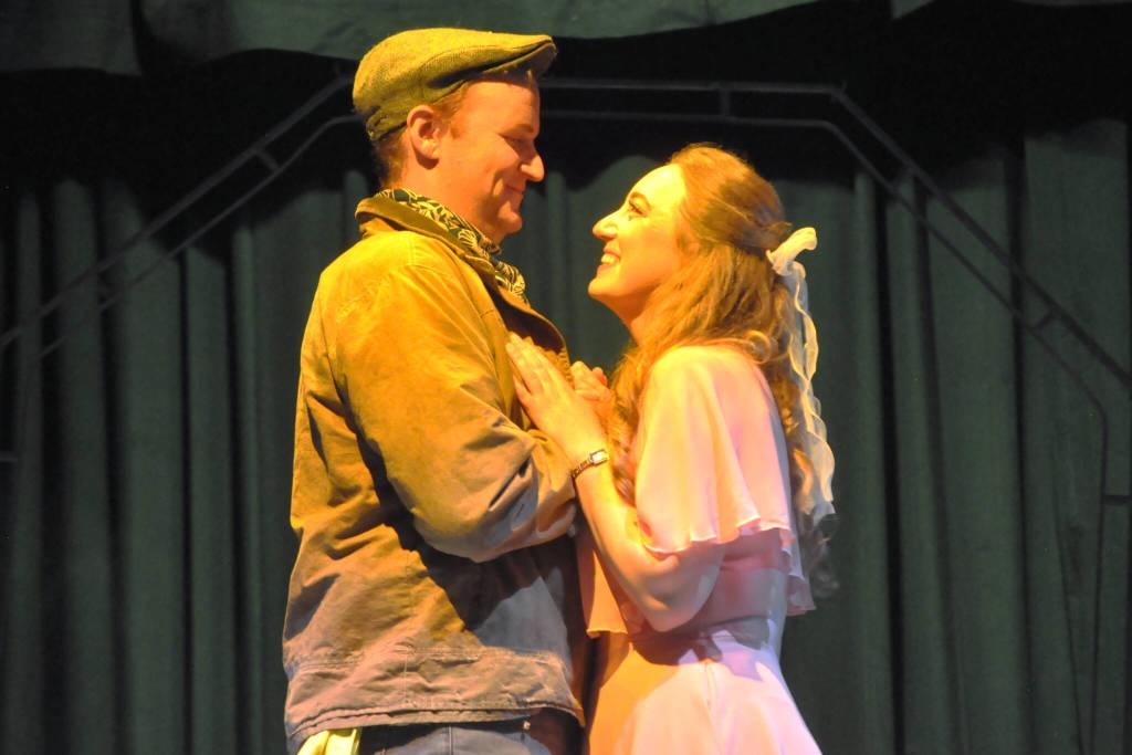 Sequim Gazette photo by Matthew Nash/ Hayden Pomeroy and Sunshine Peterson, as Bobby and Hope, embrace during a musical number in Urinetown the Musical.