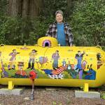 Sequim Gazette photo by Matthew Nash/ Monika Livingstone of Blyn/Gardiner stands by her propane tank she spent about a month designing and painting after feeling inspired by The Beatles Yellow Submarine.