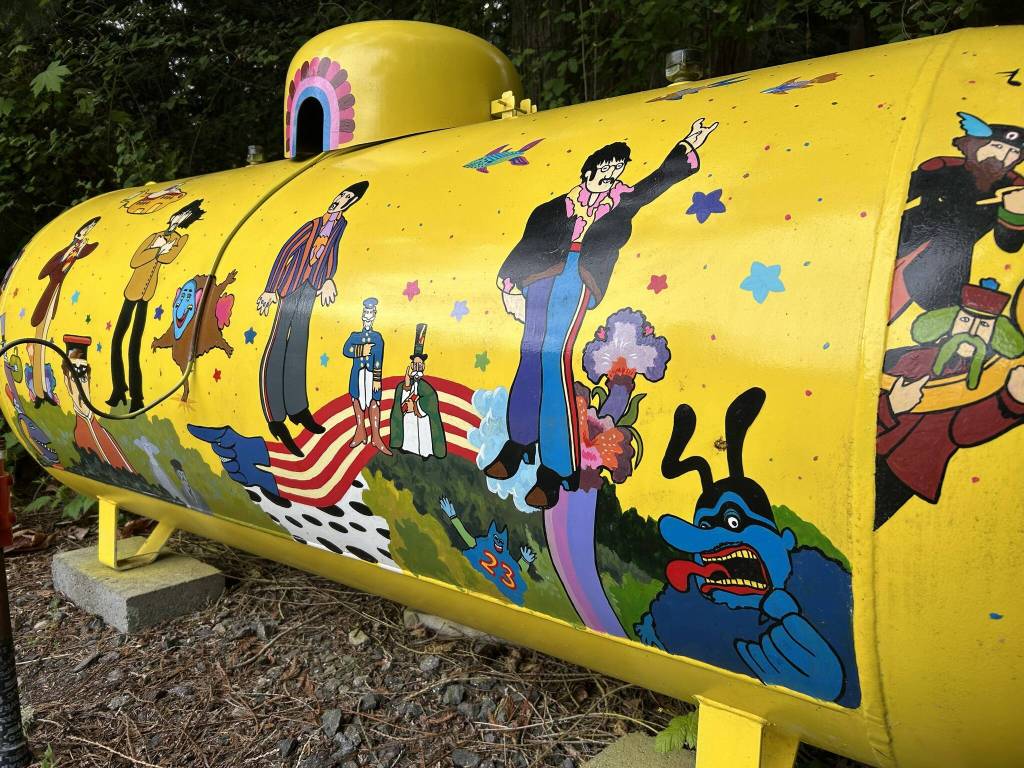 Sequim Gazette photo by Matthew Nash/ As she progressed, Monika Livingstone realized she wanted more than just the four Beatles on her propane tank inspired by the Yellow Submarine, she added multiple characters and images from the animated film.