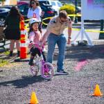 Sequim Gazette photos by Monica Berkseth 
Ember Cooper, 6, of Sequim receives some obstacle course help from Assistant Scoutmaster Marcus Spooner of Cub Scout Pack 4490.