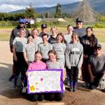 Ashtyn Messinger plays elite basketball and soccer in Sequim and recently started playing softball. Here, her softball team poses with a handmade get well card for their teammate. Coach Chad Celestres, who organized a GoFundMe <a href="https://gofundme.com/f/AshtynMessinger" target="_blank">campaign</a> for the Messinger family, is in the middle of the back row wearing a black cap.