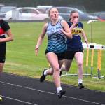 Vaira Luke, center, runs the 100 meters where she ran a personal best (14.77) at the Olympic League meet.