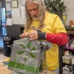 Volunteer Paul Stehr-Green prepares plastic bags for food bank clients.