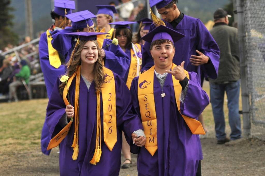 Sequim seniors Makenna Sweeney and Adrian Aragon keep the mood fun as they walk to the graduation ceremony.