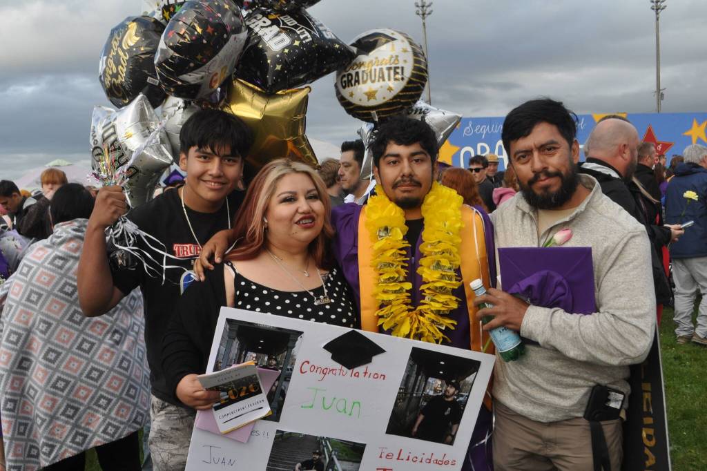 Sequim Gazette photo by Matthew Nash/ Juan Moreno Jr. stands with his family, from left, brother Diego, mom Adriana Sixtos, and dad Juan Moreno Sr. after his graduation from Sequim High School.