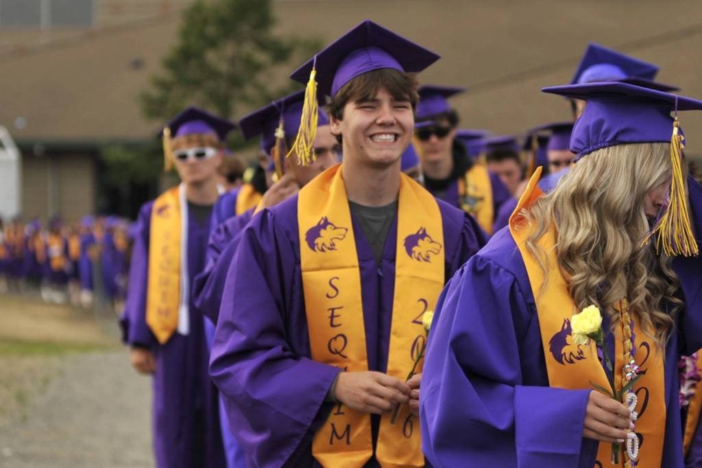 Huckleberry Grafton smiles as he and 218 other SHS seniors walk to their graduation ceremony.