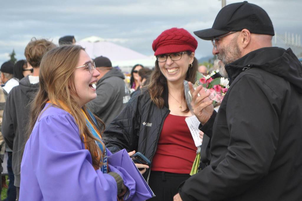 Sequim Gazette photo by Matthew Nash/ Recent graduate Emma Gilliam, one of eight valedictorians, shares a fun moment with her parents Kecia and Glenn Gilliam after the graduation ceremony.