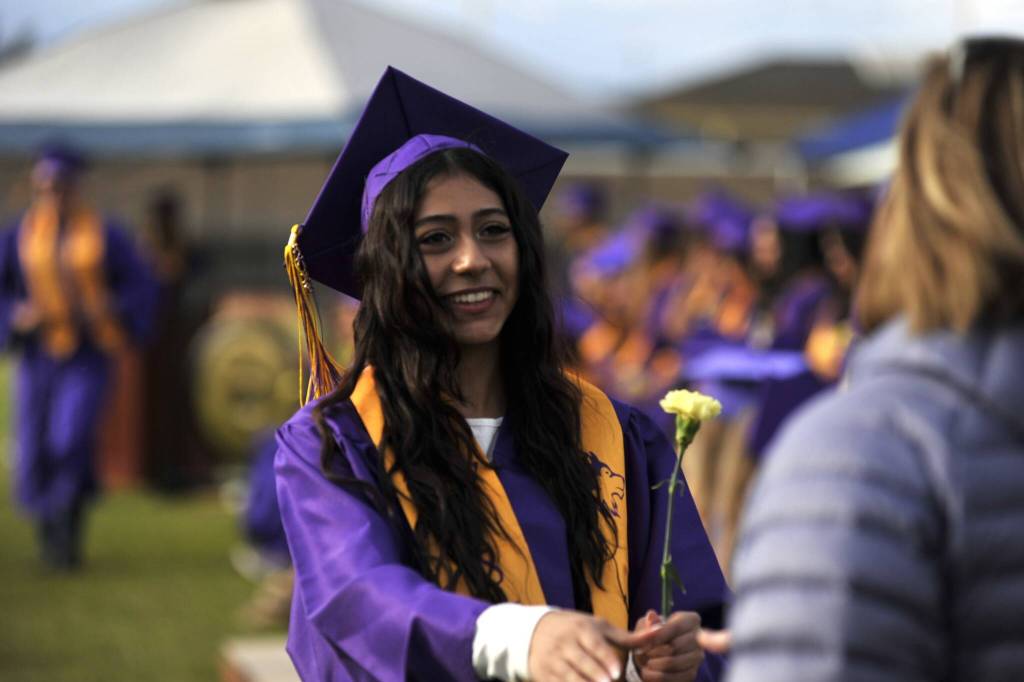 Amal Awawdeh smiles as she receives her diploma from Sequim School Board director Patrice Johnston.