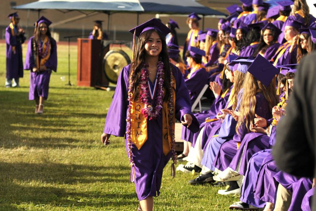 Sequim Gazette photo by Matthew Nash/ Tiffany Lam walks by her classmates as she readies to receive her high school diploma.