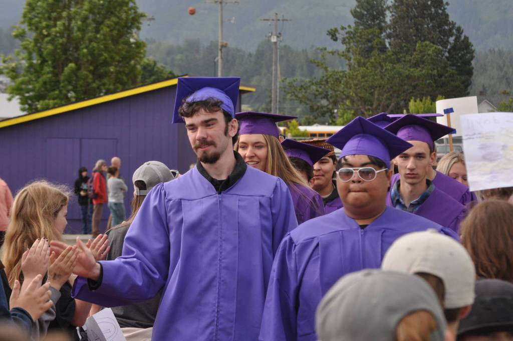 Sequim Gazette photo by Matthew Nash/ Colin Feik and Grillien Morrill are greeted by hundreds of younger Sequim students during the SHS Grad Walk.