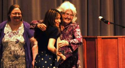 Gloria Dahlquist, center, hugs Kaylee Torres, a Sequim senior, and provided her a scholarship on behalf of the Sequim Philanthropic Educational Organization (P.E.O.). Looking on is Maribeth Kelly, on left.