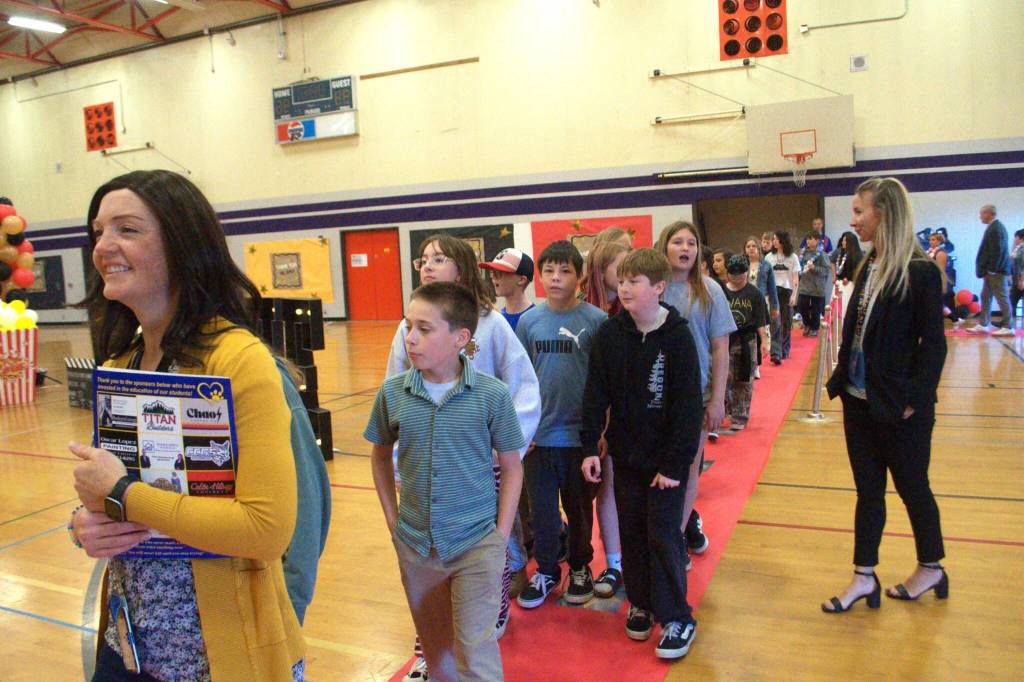 Sequim Gazette photo by Matthew Nash/
Stephanie Dormer, a fifth grade teacher, leads her class down a red carpet inside Olympic Peninsula Academy for Helen Haller Elementary’s fifth grade Moving On ceremony.