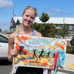 Dave Logan/for Olympic Peninsula News Group/
The womens winner of the North Olympic Discovery Marathon Rissa Eilmes of Bremerton with her first-place poster.