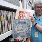 Sequim Gazette photo by Matthew Nash/ KSQMs Administrative Director Tama Bankston shows off some of the many records the radio station has on file.