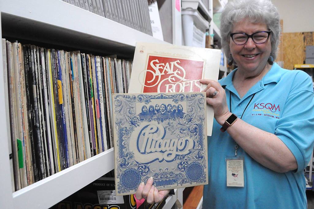 Sequim Gazette photo by Matthew Nash/ KSQMs Administrative Director Tama Bankston shows off some of the many records the radio station has on file.