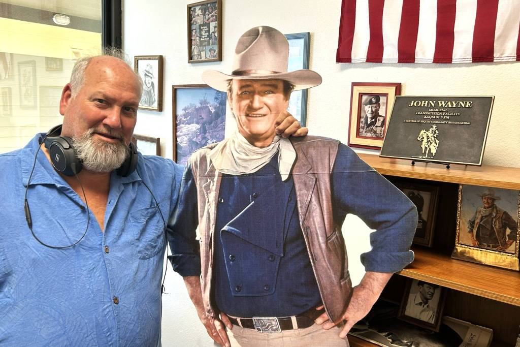 Sequim Gazette photo by Matthew Nash/ KSQM volunteer Jeff Davenport stands in the John Wayne Room inside KSQM 91.5 FMs entrance.
