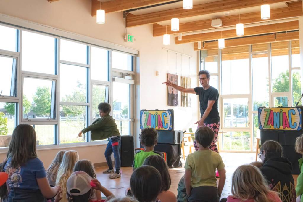 Sequim Gazette photo by Monica Berkseth/ Avi Knapp, 8, of Sequim, wasnt shy about showing off his self-taught dance moves alongside Alex Zerbe, who performs as The Zaniac. Zerbe, a two-time Guinness World Record holder, has appeared on Americas Got Talent and Last Comic Standing.