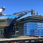 Sequim Gazette photo by Matthew Nash
Crew members with Pioneer Builders Supply Co. deliver shingles on June 17 for the new roof being installed at Sequim Middle School. Its the first new roof since it opened in 1998.