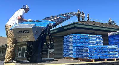 Sequim Gazette photo by Matthew Nash
Crew members with Pioneer Builders Supply Co. deliver shingles on June 17 for the new roof being installed at Sequim Middle School. Its the first new roof since it opened in 1998.