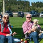 Sequim Gazette photo by Monica Berkseth/ Kim Koons and Peter Bray enjoy a picnic with their pup in Carrie Blake Community Park after music concluded on July 4.