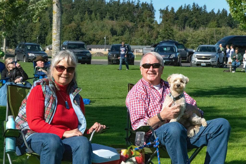 Sequim Gazette photo by Monica Berkseth/ Kim Koons and Peter Bray enjoy a picnic with their pup in Carrie Blake Community Park after music concluded on July 4.