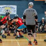 Sequim Gazette photos by Emily Matthiessen
Referees observe closely as this group of roller derby athletes gets into starting position for a bout during last Saturdays game in the Sequim Boys & Girls Club. At the far right the home team Scandals jammer, Jaden Friedle, takes a breath and concentrates as visiting players from the Walla Walla Sweets get in position to block Friedles progress.
