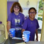 Sequim Gazette file photo by Matthew Nash/ Tilly Lundstrom, left, now going by Meadow, and Ali Edgecombe serve up lavender lemonade at Nelsons Duckpond & Lavender Farm in 2019 with sales benefiting the Sequim Food Bank. Nelsons Duckpond has been part of Sequim Lavender Festival since its inception 30 years ago. Lundstrom, now in college, donated proceeds from her sales for years to area nonprofits.