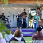 Sequim Gazette photo by Tom Buscher/ Members of Vibrations of Particles n Waves perform for visitors at Purple Haze Lavender Farm on July 18. Audience members watch from shaded seating as the band provides live music during the farms annual festival.